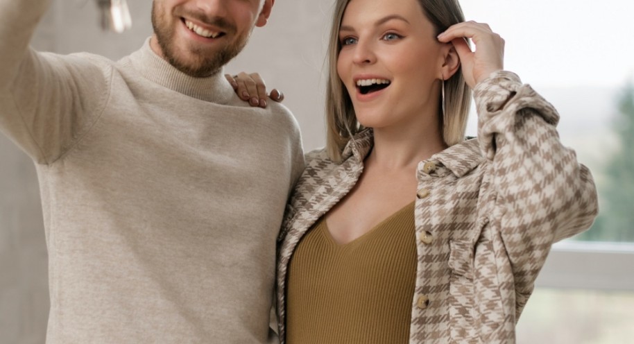 A Couple Holding the Keys to Their New Home
