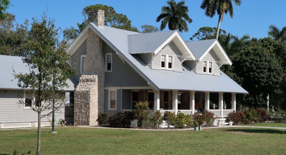 brown and white concrete house near green grass field